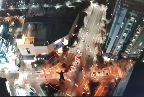 This image of a man base jumping from a skyscraper in Busan is captured from a video posted on the jumper's social media account. (PHOTO NOT FOR SALE) (Yonhap)