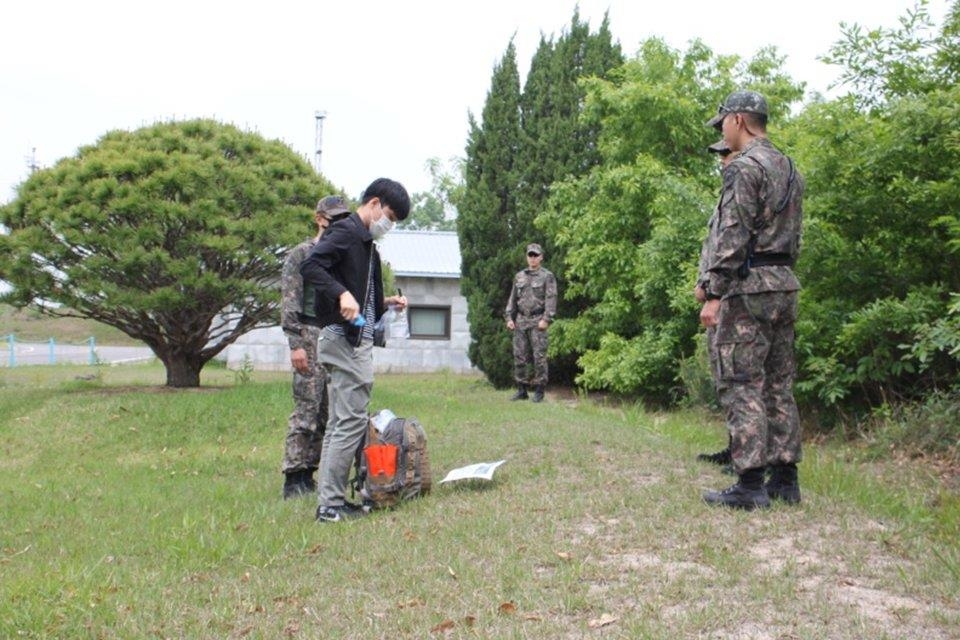 In this photo, captured from the United Nations Command's Twitter account, officials conduct a survey on the risk of African swine fever inside the Demilitarized Zone (DMZ) separating the two Koreas on May 27, 2020. (PHOTO NOT FOR SALE) (Yonhap)