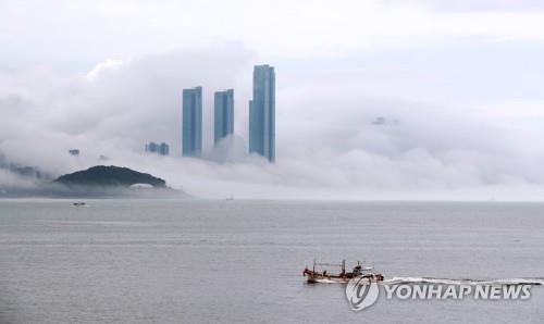 High-rise residential buildings in Haeundae in the southeastern port city of Busan are shrouded in sea fog on July 7, 2022, the day of "soseo," one of the 24 seasonal divisions of the year that marks the day of minor heat. (Yonhap)