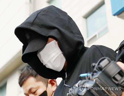 The suspect in a campus rape and death case at Inha University leaves a police station in Incheon, 27 kilometers west of Seoul, as he is escorted to the prosecution, in this July 22, 2022, file photo. (Yonhap)