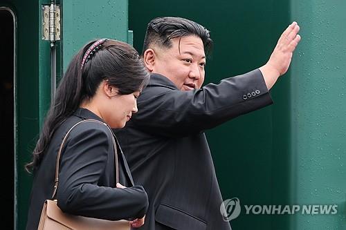 North Korean leader Kim Jong-un (R) waves to Russian officials before boarding his armored train at the railway station in Russia's Far Eastern city of Artyom to return home on Sept. 17, 2023, in this photo released by TASS. (Yonhap)