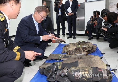 부상당한 소방관 장갑 들어보는 문 대통령