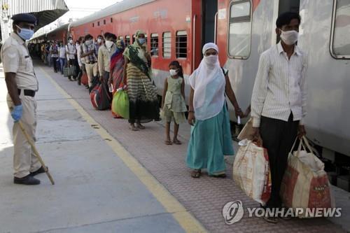 인도 서부 아메다바드에서 5월 2일 고향행 특별 열차를 타기 위해 줄을 서 있는 일용직 노동자와 가족. [AP=연합뉴스]