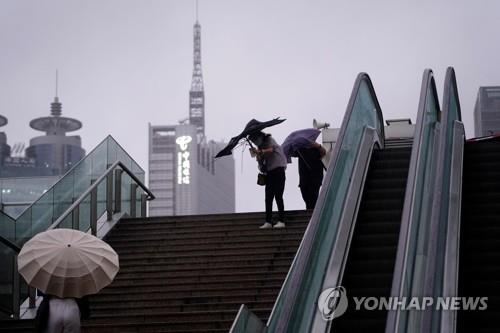 태풍 속 우산 쓴 상하이 시민들