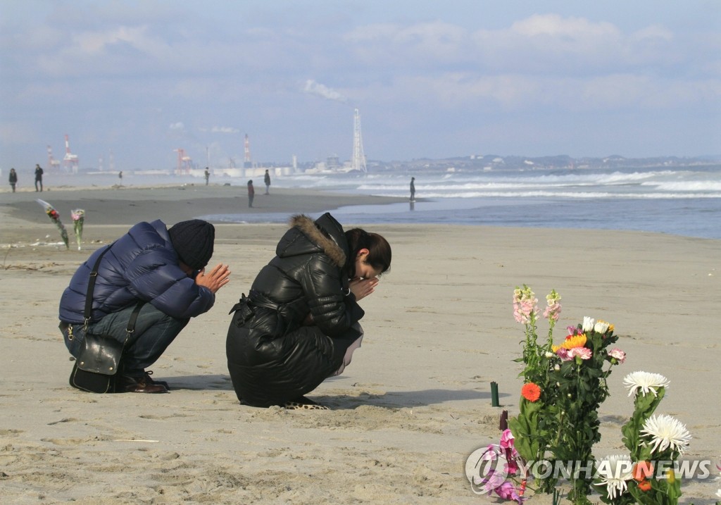 일본 센다이에서 기도하는 부부(EPA=연합뉴스)