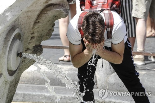 이탈리아 로마의 스페인 계단 근처 분수에서 더위를 식히는 한 남성