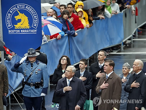 추모식 참석자들이 국기를 향해 경례하고 있다. (AP=연합뉴스)