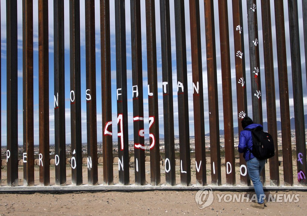 (멕시코시티 AFP=연합뉴스) 사진은 26일 미국과 접한 멕시코 국경도시 시우다드 후아레스의 국경장벽에서 한 멕시코 남자가 도널드 트럼프 미 대통령을 규탄하는 퍼포먼스를 하고 있는 모습. ymarshal@yna.co.kr