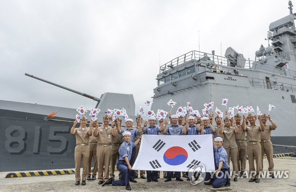 Sailors pose with flags to mark Liberation Day Sailors pose with flags to mark Liberation Day