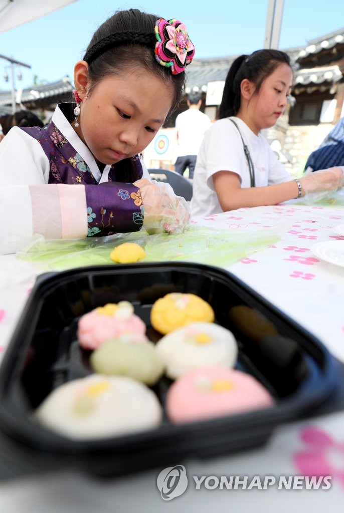 Girl concentrates on making rice cake Girl concentrates on making rice cake