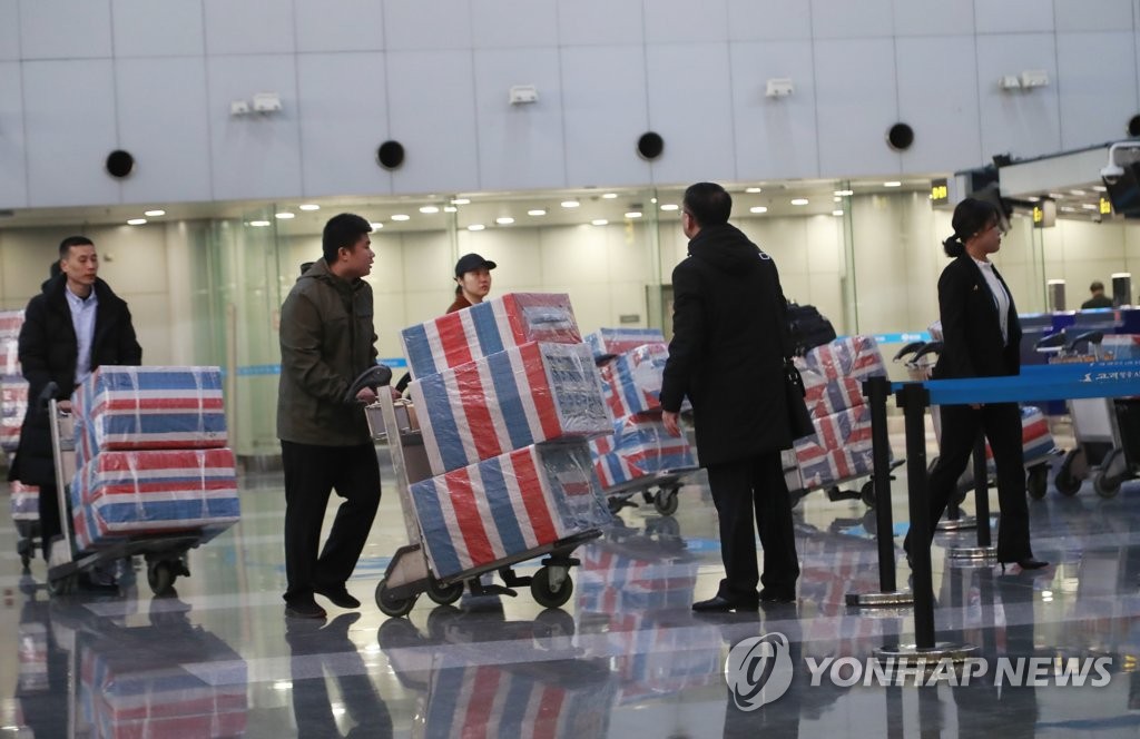 People assumed to be North Korean overseas laborers prepare to return home at Beijing Capital International Airport on Dec. 21, 2019, one day ahead of the U.N. Security Council Resolution 2397 deadline, which calls on member states to repatriate all North Koreans earning income in their jurisdictions. (Yonhap)