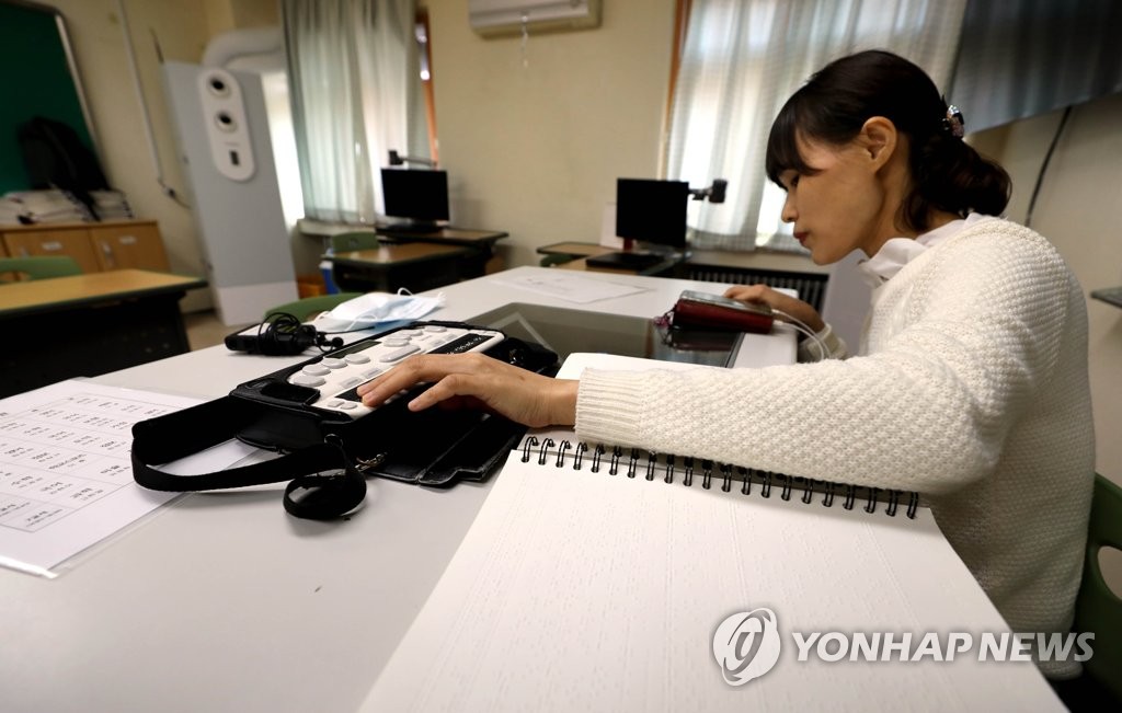 점자정보단말기와 점자책 이용해 원격수업하는 서울맹학교
