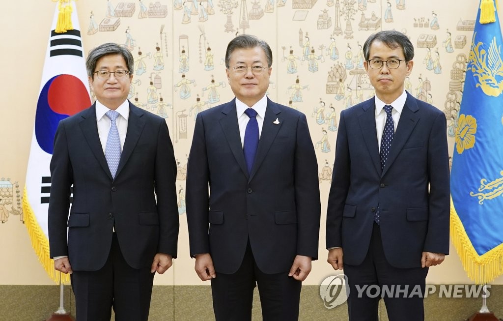 President Moon Jae-in (C) poses for a commemorative photo with New Supreme Court Justice Lee Heung-ku (R) and Kim Myeong-soo, its chief justice, at Cheong Wa Dae in Seoul on Sept. 18, 2020. (Yonhap)