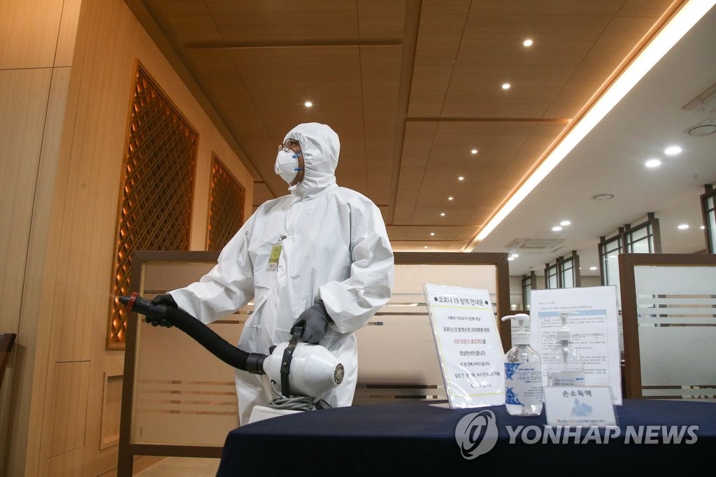A health worker clad in a protective suit disinfects a cafeteria inside the National Assembly in Seoul on June 11, 2021, after some lawmakers were diagnosed with COVID-19. (Yonhap)