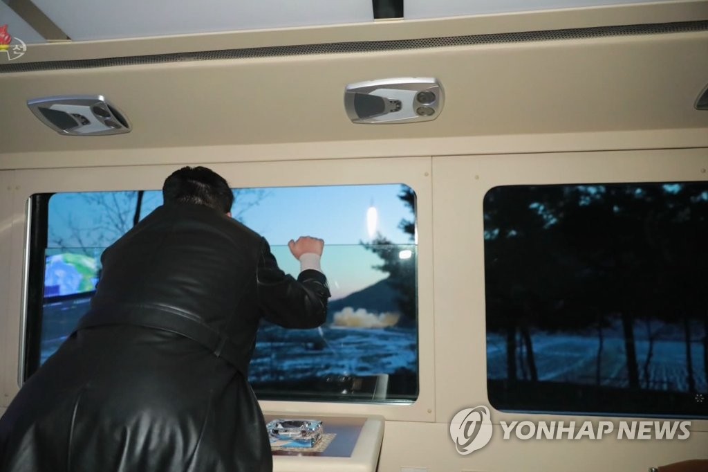 This photo, captured from North Korea's official Korean Central Television on Jan. 12, 2022, shows North Korean leader Kim Jong-un watching the firing of what the country claims to be a new hypersonic missile from a car the previous day. (For Use Only in the Republic of Korea. No Redistribution) (Yonhap)