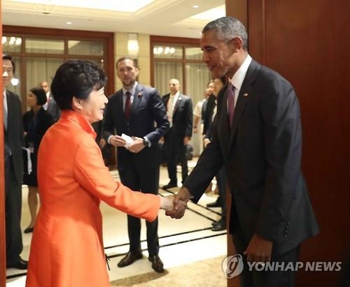 President Park Geun-hye (L) shakes hands with U.S. President Barack Obama before their talks on the sidelines of a series of summits with the Association of Southeast Asian Nations in Vientiane, Laos, on Sept. 6, 2016.