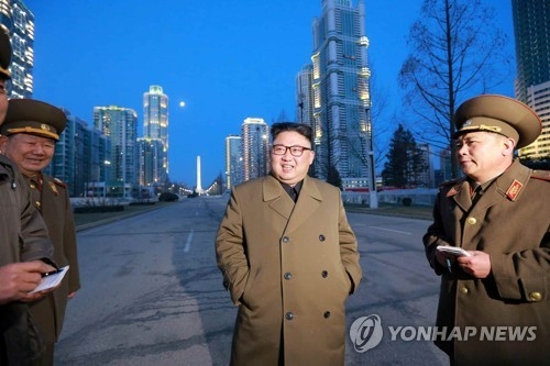 This undated file photo shows North Korean leader Kim Jong-un (C) inspecting the streets of the Yeomyung district in Pyongyang. (For Use Only in the Republic of Korea. No Redistribution) (Yonhap)
