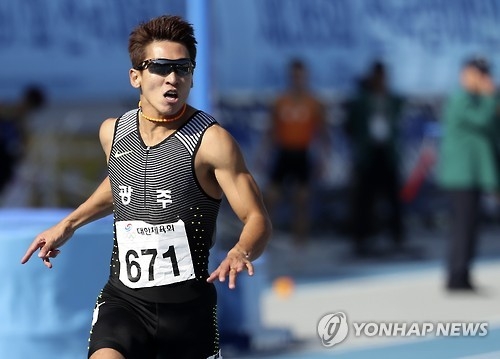 In this file photo taken on Oct. 9, 2016, South Korean sprinter Kim Kuk-young crosses the finish line first in the men's 100m final at the National Sports Festival in Asan, South Chungcheong Province. (Yonhap)