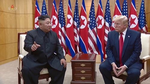 North Korean leader Kim Jong-un (L) talks with U.S. President Donald Trump at the Freedom House on the southern side of the truce village of Panmunjom in the Demilitarized Zone, which separates the two Koreas, on June 30, 2019, in this image captured from a documentary film aired by North Korea's official Korean Central TV on Jan. 10, 2020. (For Use Only in the Republic of Korea. No Redistribution) (Yonhap)