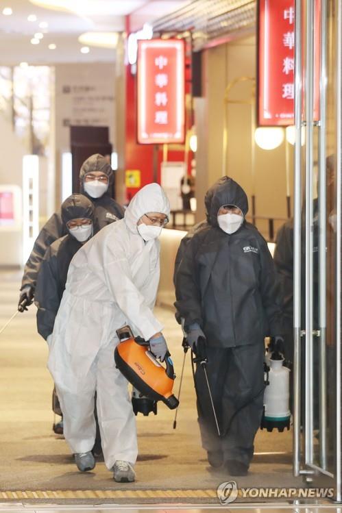 Workers disinfect a shopping mall in Seoul on Feb. 10, 2020, amid fears over the spreading new coronavirus. (Yonhap)
