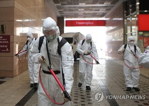 Members of the Army Second Operational Command sterilize a retail outlet in Daegu, the epicenter of South Korea's coronavirus outbreak, on March 5, 2020, in this photo provided by the command. (PHOTO NOT FOR SALE) (Yonhap)