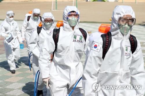 Soldiers disinfect the street near a subway station in Daegu, South Korea, March 24, 2020. (Yonhap)
