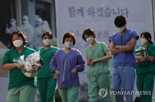 Medical workers walk to a resting place after working a shift for coronavirus patients at Dongsan Hospital in Daegu, 302 kilometers southeast of Seoul, on April 9, 2020. (Yonhap)