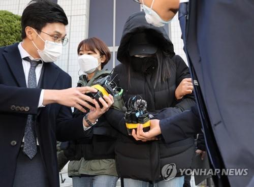 A woman leaves the Seoul Southern District Court on Nov. 11, 2020, after attending a hearing on the prosecution's request for a warrant for her arrest on charges of abusing her adopted baby to death. (Yonhap)