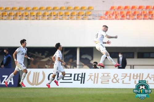 In this Nov. 7, 2020, file photo provided by the Korea Professional Football League, Lars Veldwijk of Suwon FC (R) celebrates a goal against FC Anyang in a K League 2 match at Anyang Sports Complex in Anyang, 23 kilometers south of Seoul. (PHOTO NOT FOR SALE) (Yonhap)