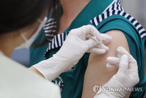 The undated file photo shows a health worker injecting a COVID-19 vaccine shot. (Yonhap)
