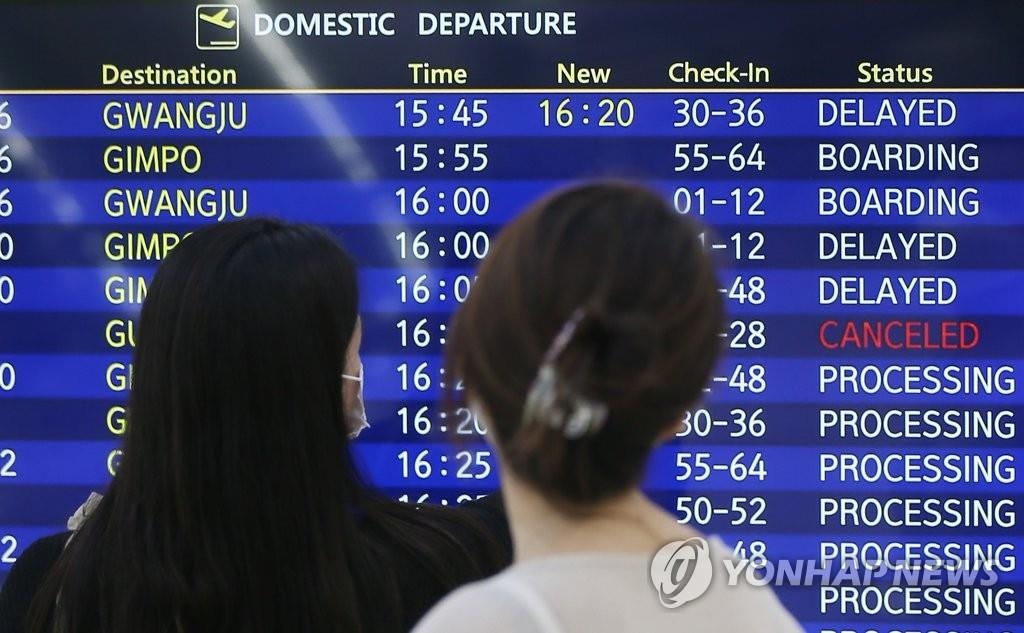 A departures board displays times of flights to and from Jeju, South Korea, affected by Typhoon Omais, on Aug. 23, 2021. (Yonhap)