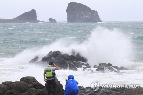 A police officer watches the choppy water off the southern island of Jeju, South Korea, on Sept. 15, 2021. (Yonhap)