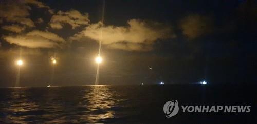 This photo provided by the Coast Guard shows rescuers search the sea off Gunsan, North Jeolla Province, on Oct. 20, 2021, after a Chinese fishing boat capsized, leaving seven crewmen missing. (PHOTO NOT FOR SALE) (Yonhap)