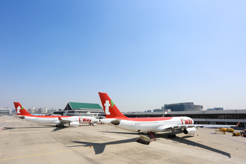 This file photo offered by T'way Air shows its A330-300 chartered planes at Incheon International Airport in Incheon, just west of Seoul. (PHOTO NOT FOR SALE) (Yonhap) 