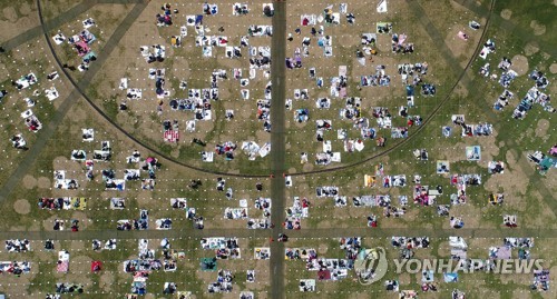 This file photo shows people attending the Wonderland Festival, an outdoor music festival, at Seoul's Olympic Park on May 1, 2022. (Yonhap)