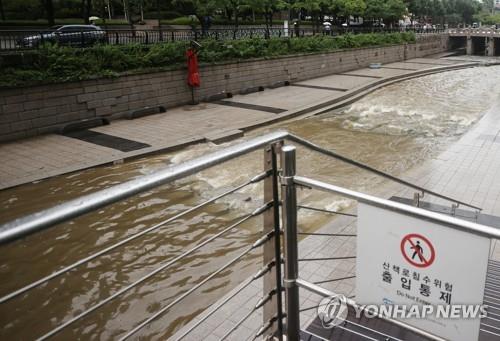 An entrance to Cheonggyecheon, a stream in central Seoul, remains blocked on June 30, 2022, amid heavy downpours.