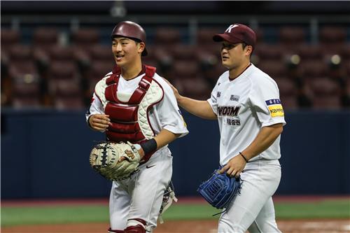 Kiwoom Heroes starter Choi Won-tae (R) pats his catcher Kim Dong-hyun on the back during a Korea Baseball Organization preseason game against the Samsung Lions at Gocheok Sky Dome in Seoul on March 24, 2023, in this photo provided by the Heroes. (PHOTO NOT FOR SALE) (Yonhap)