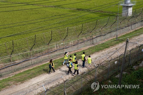 This file photo, taken in September 2022, shows participants walking on a peace-themed hiking trail along the Demilitarized Zone (DMZ) in Paju, 28 kilometers northwest of Seoul. (Yonhap)