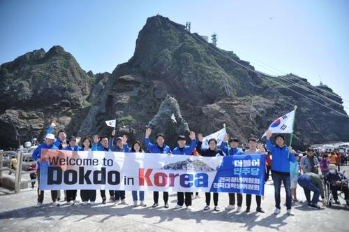 This image, captured from a Facebook post of Rep. Jeon Yong-gi of the main opposition Democratic Party, shows his visit with other party members to the country's easternmost islets of Dokdo on May 2, 2023. (PHOTO NOT FOR SALE) (Yonhap)