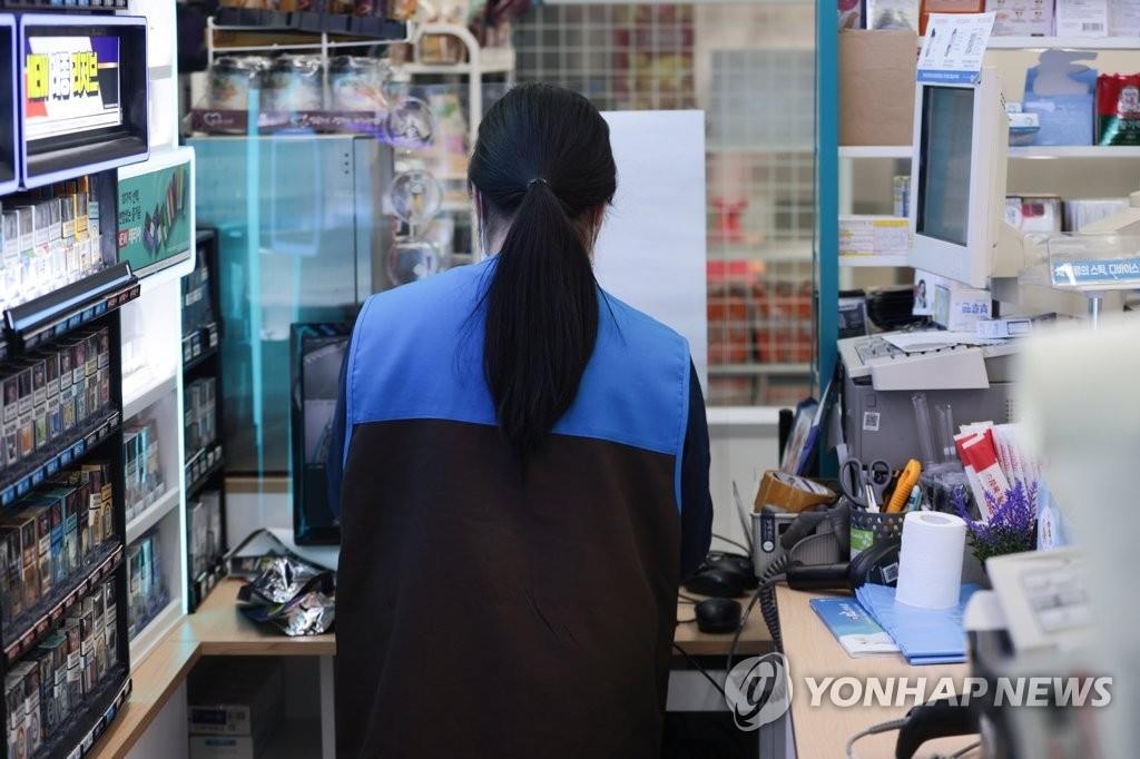 This undated file photo shows a woman working at a convenience store in South Korea. (Yonhap)