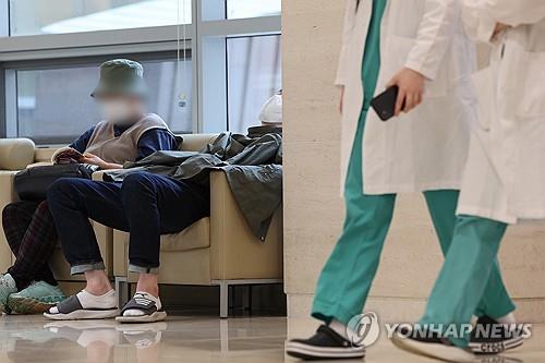 Visitors sit down in a lobby of a general hospital in Seoul on April 26, 2024. (Yonhap)