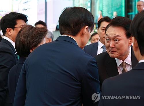 President Yoon Suk Yeol greets Cho Kuk, leader of the minor opposition Rebuilding Korea Party, during an event marking Buddha's birthday at Jogye Temple in central Seoul on May 15, 2024. (Yonhap) 