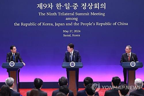 El presidente Yoon Suk Yeol (centro) habla durante una rueda de prensa conjunta de la novena cumbre trilateral con el primer ministro japonés Fumio Kishida (izq.) y el primer ministro chino Li Qiang en la antigua oficina presidencial de Cheong Wa Dae en Seúl el 27 de mayo de 2024. ( Yonhap)