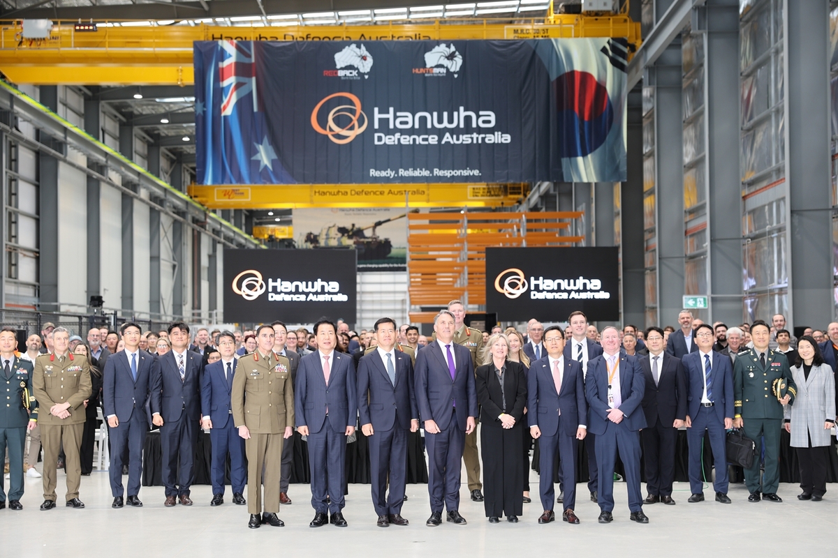 This photo, taken Aug. 23, 2024, and provided by Hanwha Aerospace, shows officials from the company and the local government attending the opening event of its first overseas armored vehicle plant, H-ACE, in Geelong, Australia. (PHOTO NOT FOR SALE) (Yonhap)