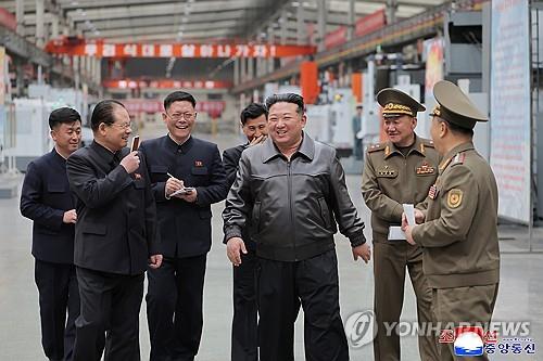 North Korean leader Kim Jong-un (3rd from R) smiles as he inspects a munitions enterprise, in this undated photo released by the North's official Korean Central News Agency on May 7, 2025. The name and location of the factory were not disclosed. (For Use Only in the Republic of Korea. No Redistribution) (Yonhap)