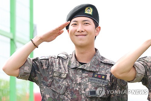 BTS' RM gives a salute to his fans at a park in Chuncheon, Gangwon Province, on June 10, 2025, after being discharged from South Korea's mandatory military service the same day. (Yonhap)