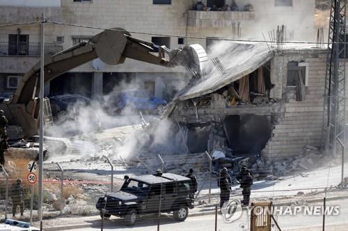 22일 오전 수르 바헤르 마을에서 건물을 철거하는 이스라엘군 굴삭기