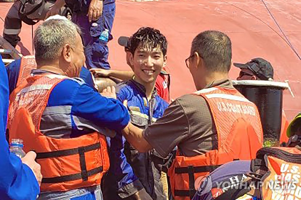 This image released by the U.S. Coast Guard via AP shows a crew member of the cargo ship Golden Ray as he is helped off the capsized ship on Sept. 9, 2019. (Yonhap)