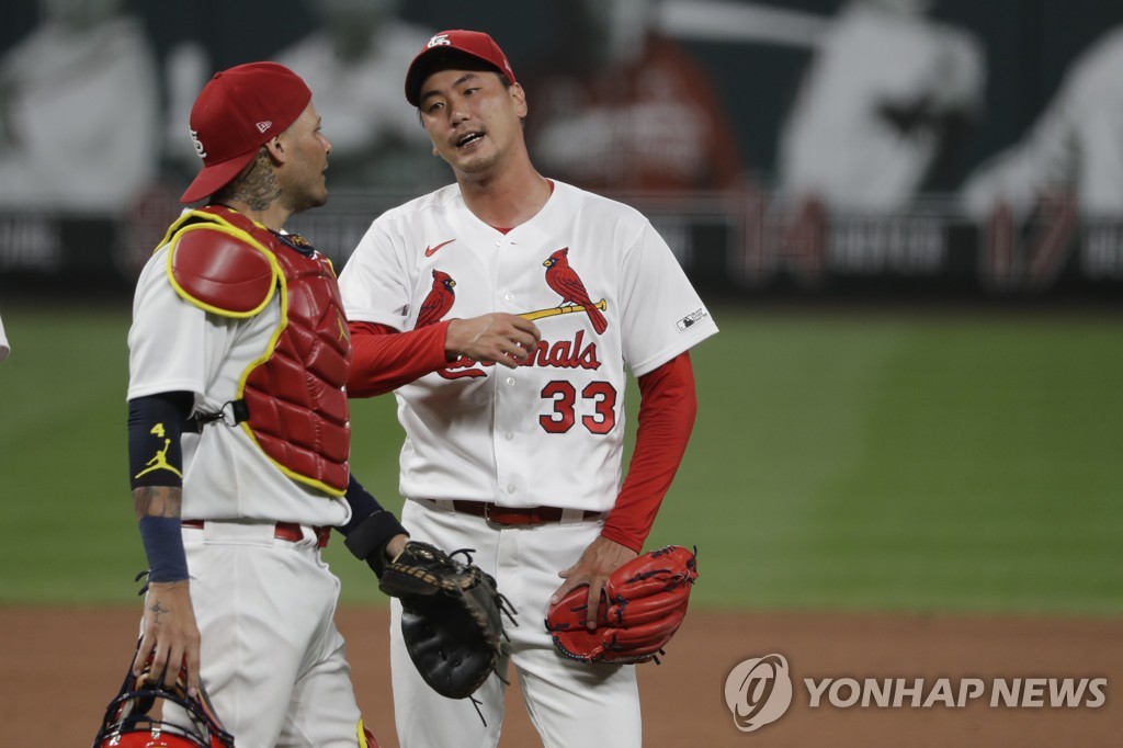 In this AP photo, St. Louis Cardinals pitcher Kim Kwang-hyun (R) celebrates with catcher Yadier Molina after saving a 5-4 victory over the Pittsburgh Pirates in St. Louis on July 24, 2020. (Yonhap)