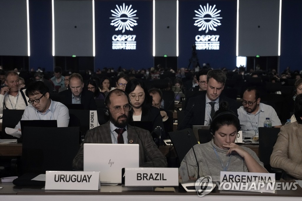 심각한 표정의 COP27 참석자들. 
